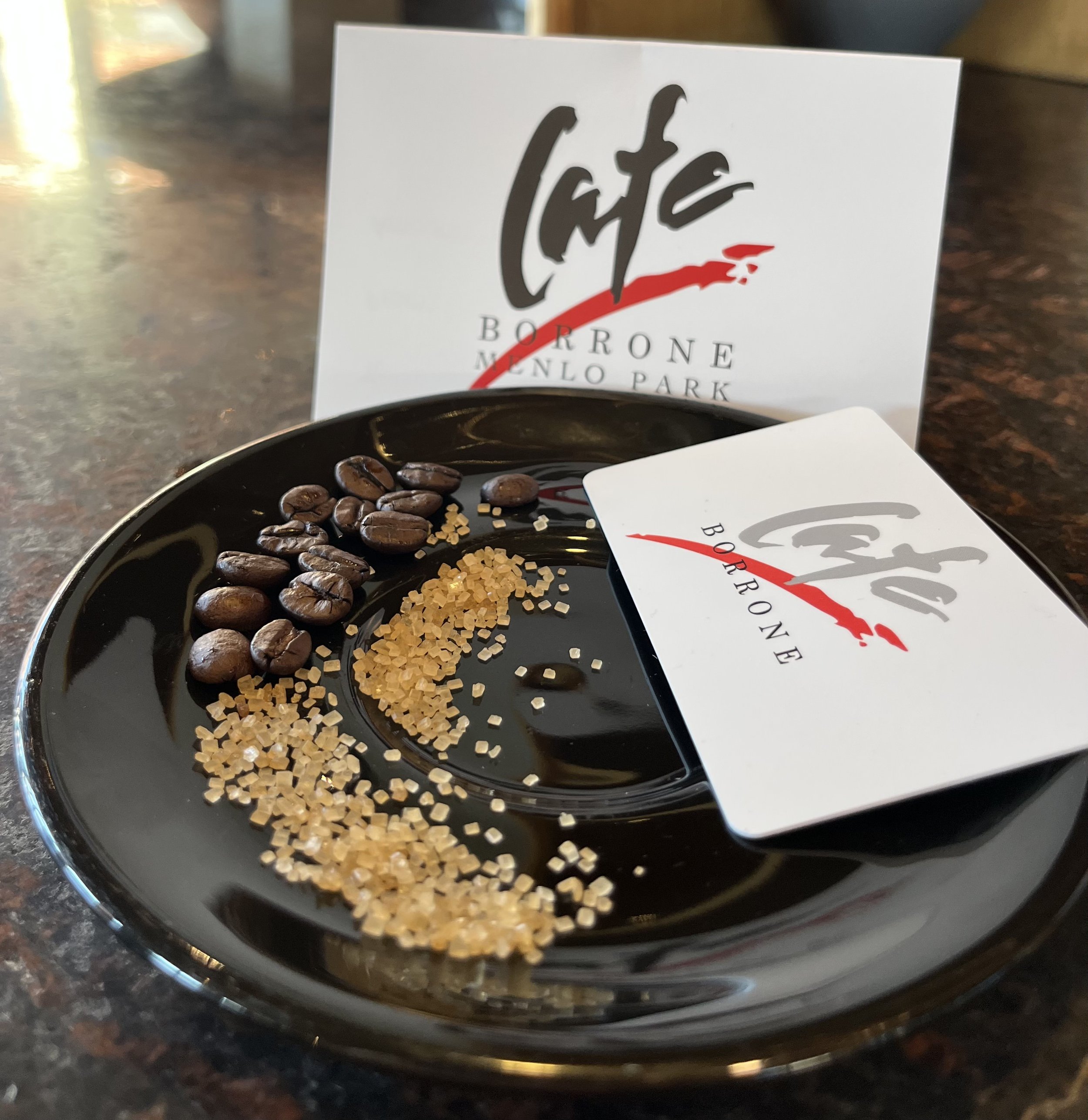 Coffee beans and sugar on a saucer