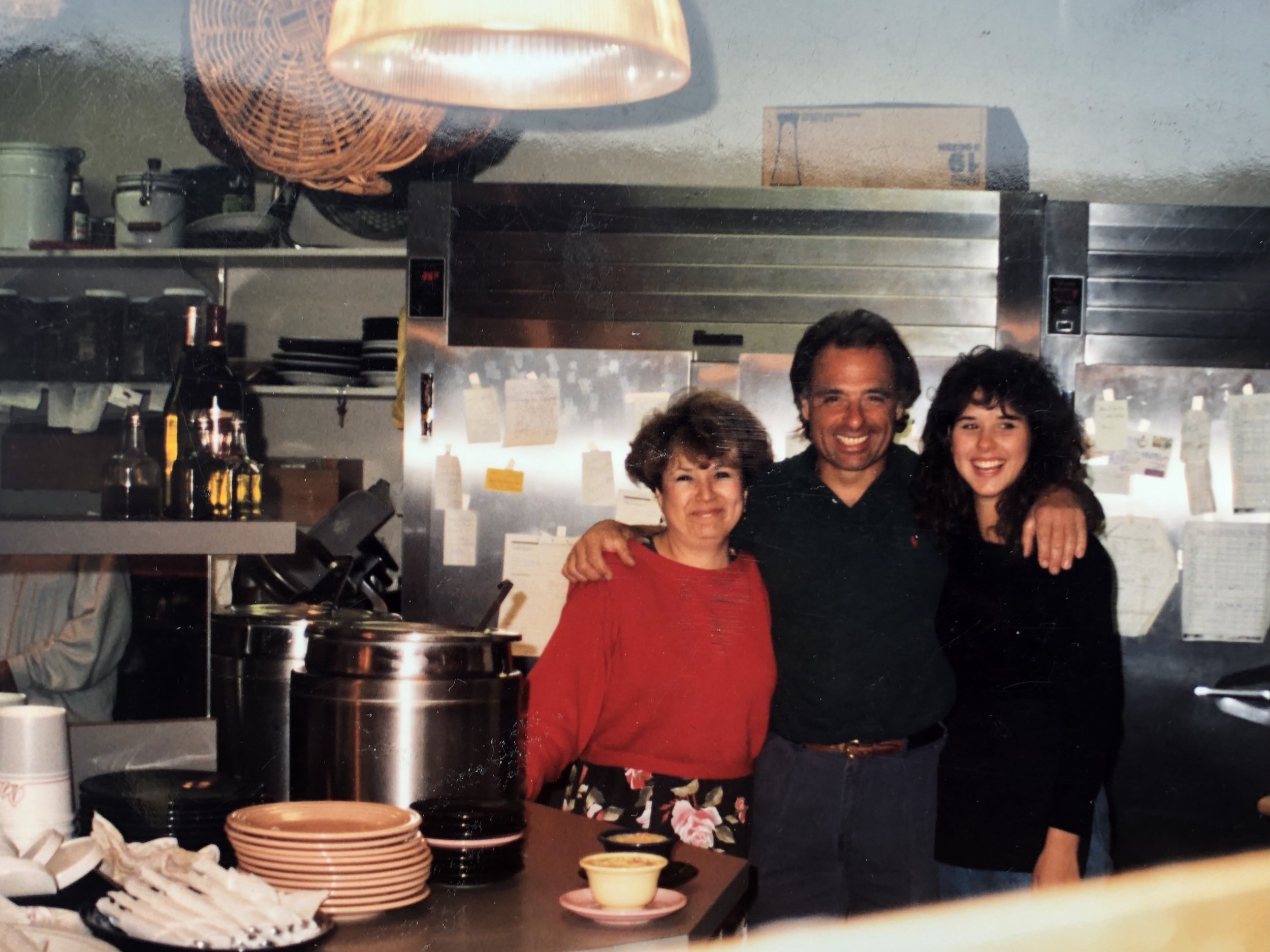 Roy, Rose and their daughter behind the counter at the original Cafe Borrone kitchen