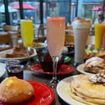 Brunch spread with mimosas, pancakes and pastries on the patio
