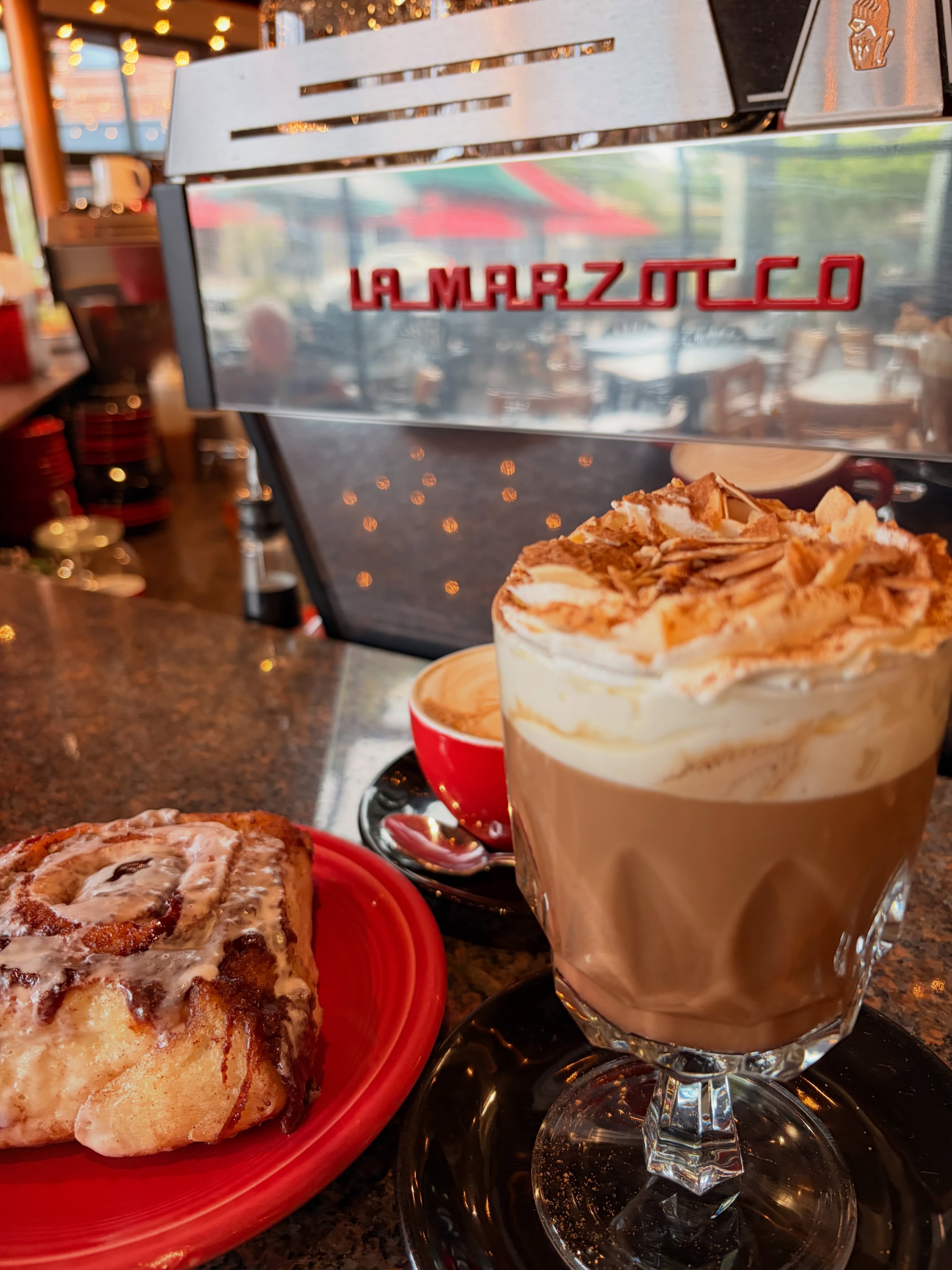 Mocha with whipped cream and a cinnamon roll at the espresso bar
