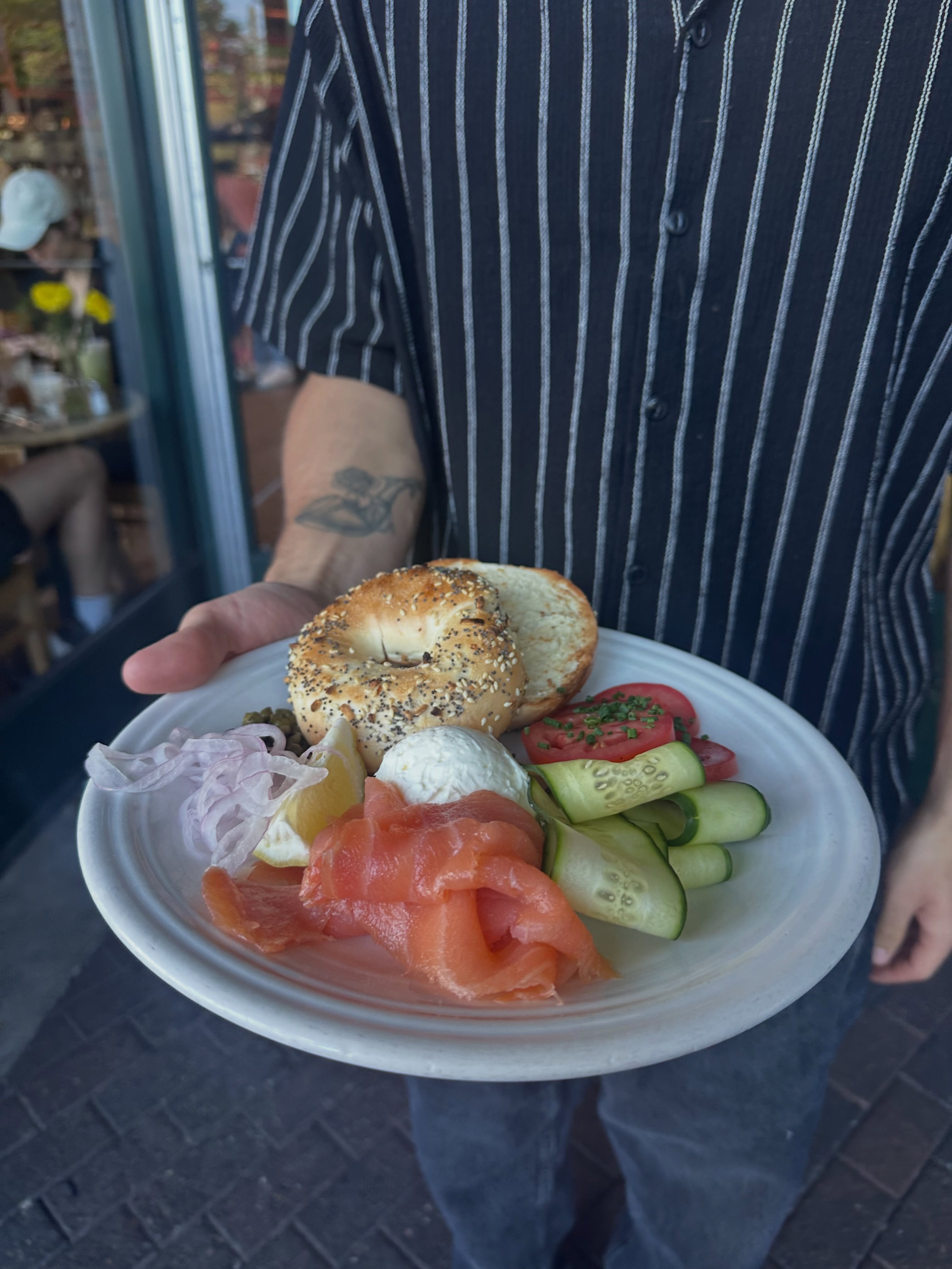 Bagel and lox platter with capers, cucumber and tomato