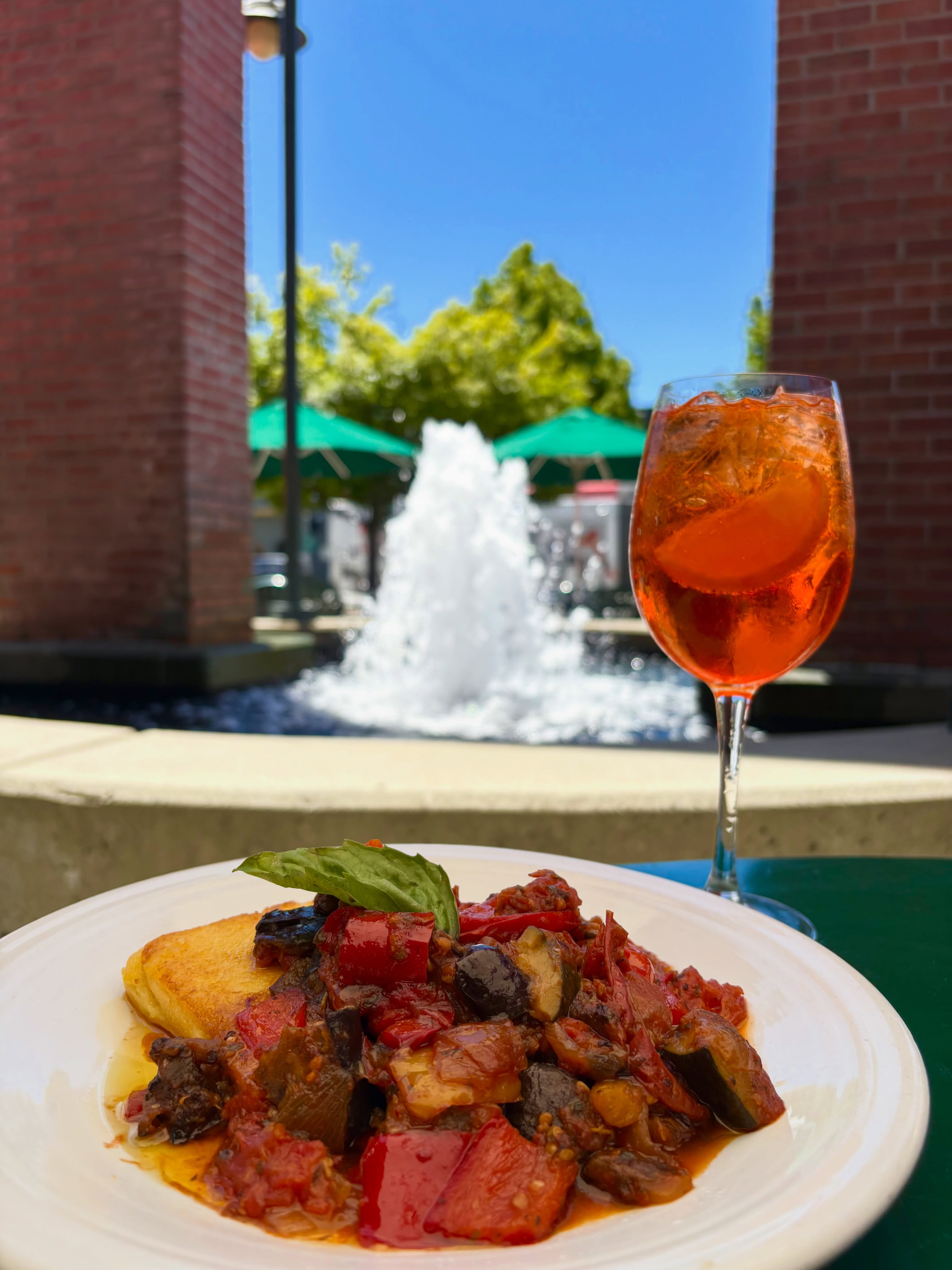 Grilled polenta with ratatouille and an Aperol spritz by the fountain