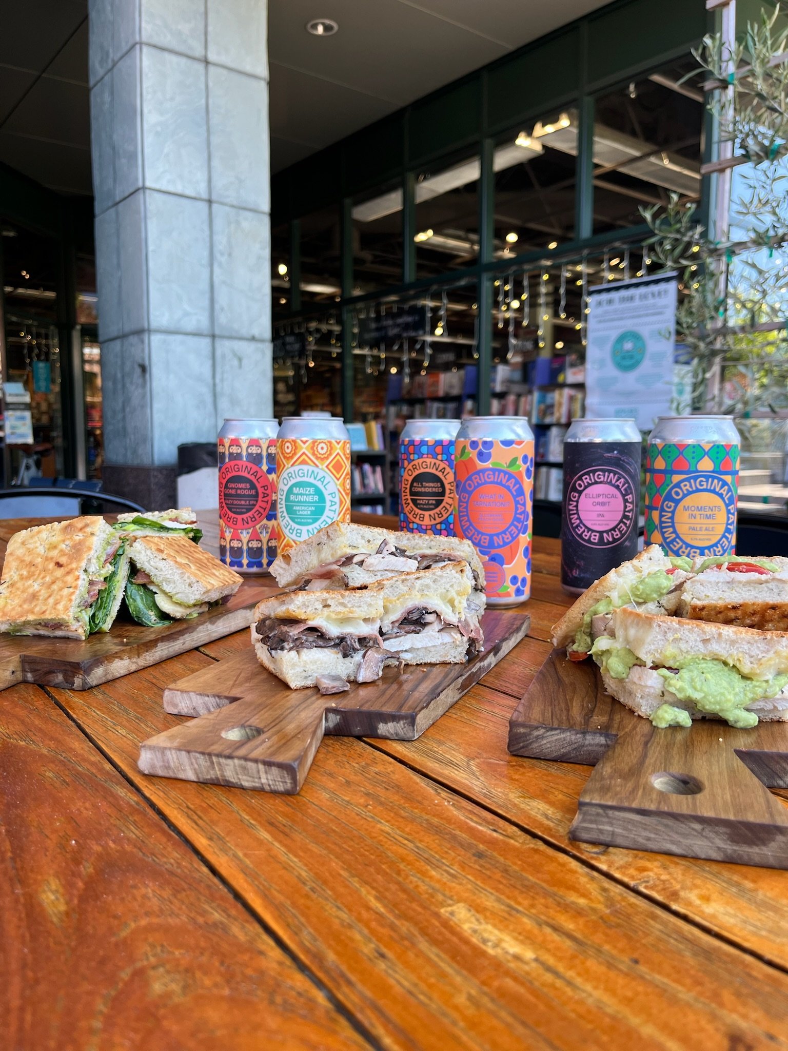 House-made sandwiches and local craft beer on a plaza table